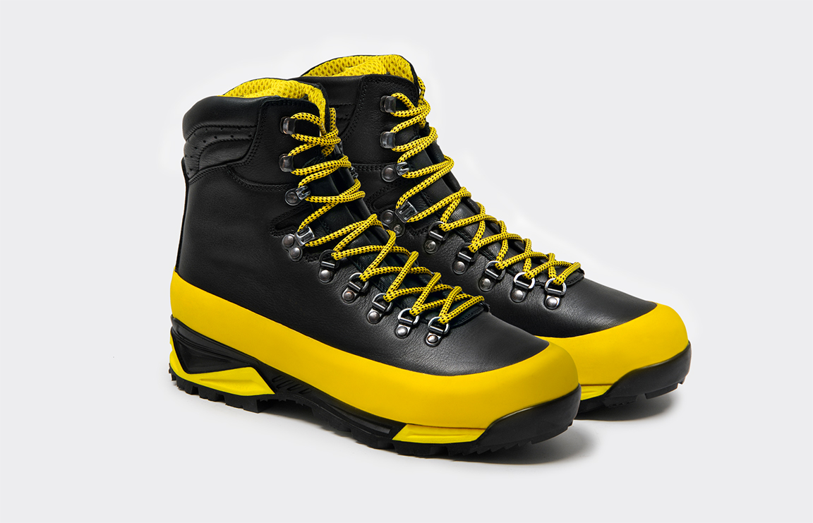 Pair of black leather trekking boots with blue Gripp bands and blue laces