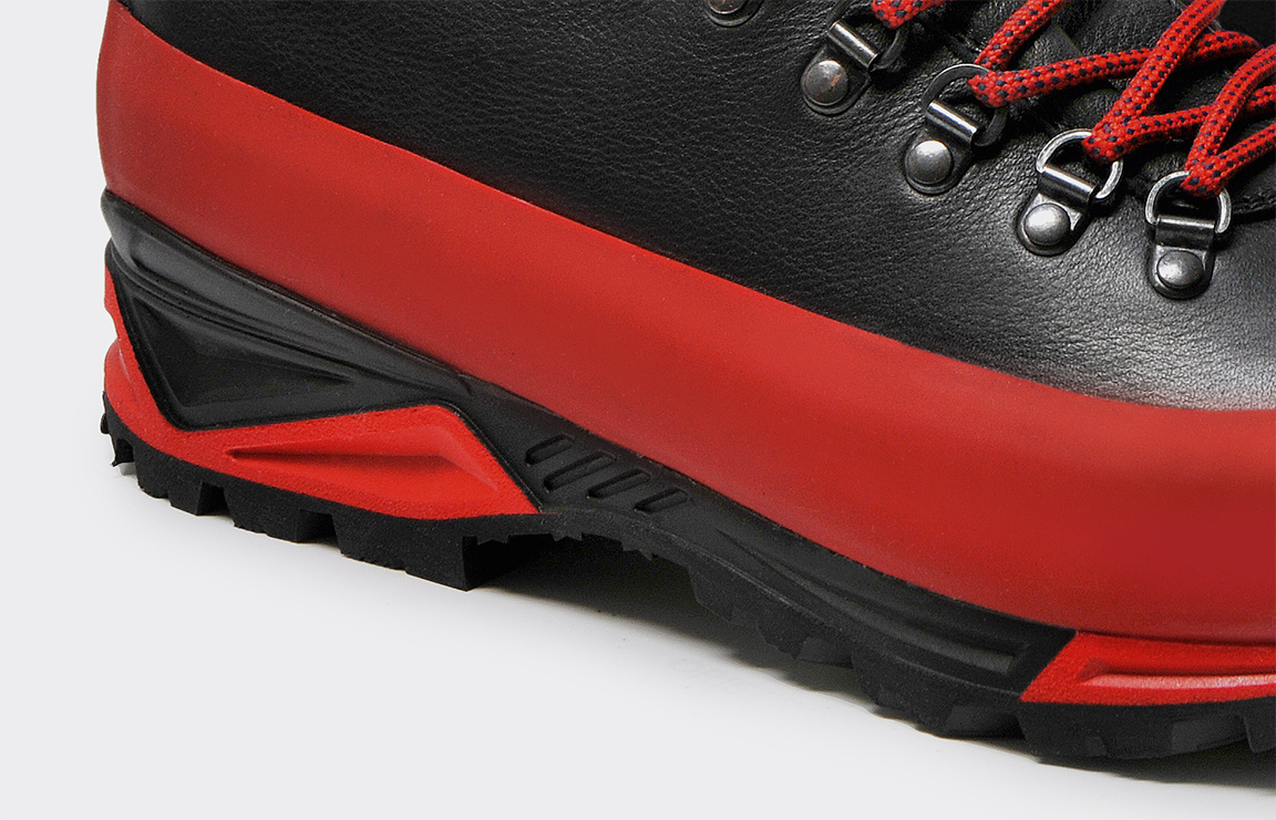 Close-up of a yellow Gripp band wrapping the toe of a black trekking boot