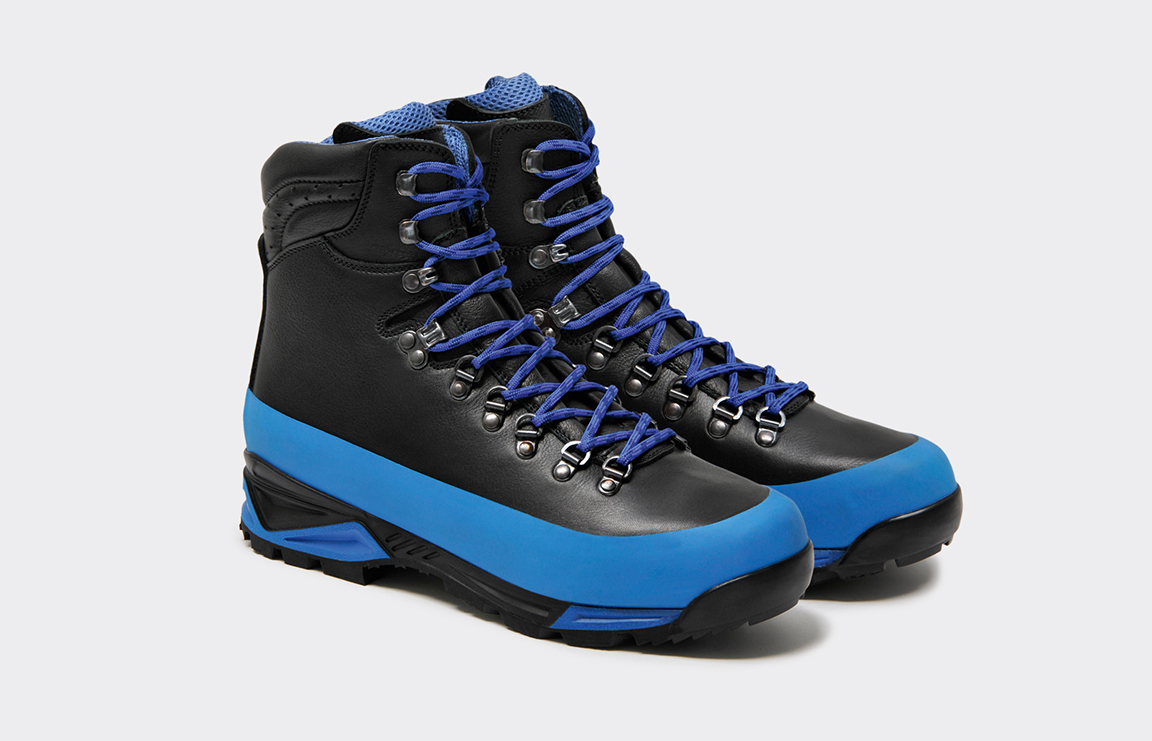 Pair of black leather trekking boots with yellow Gripp bands and yellow laces