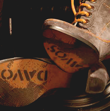 Suede lace-up boot with a DAVOS-branded expanded rubber sole