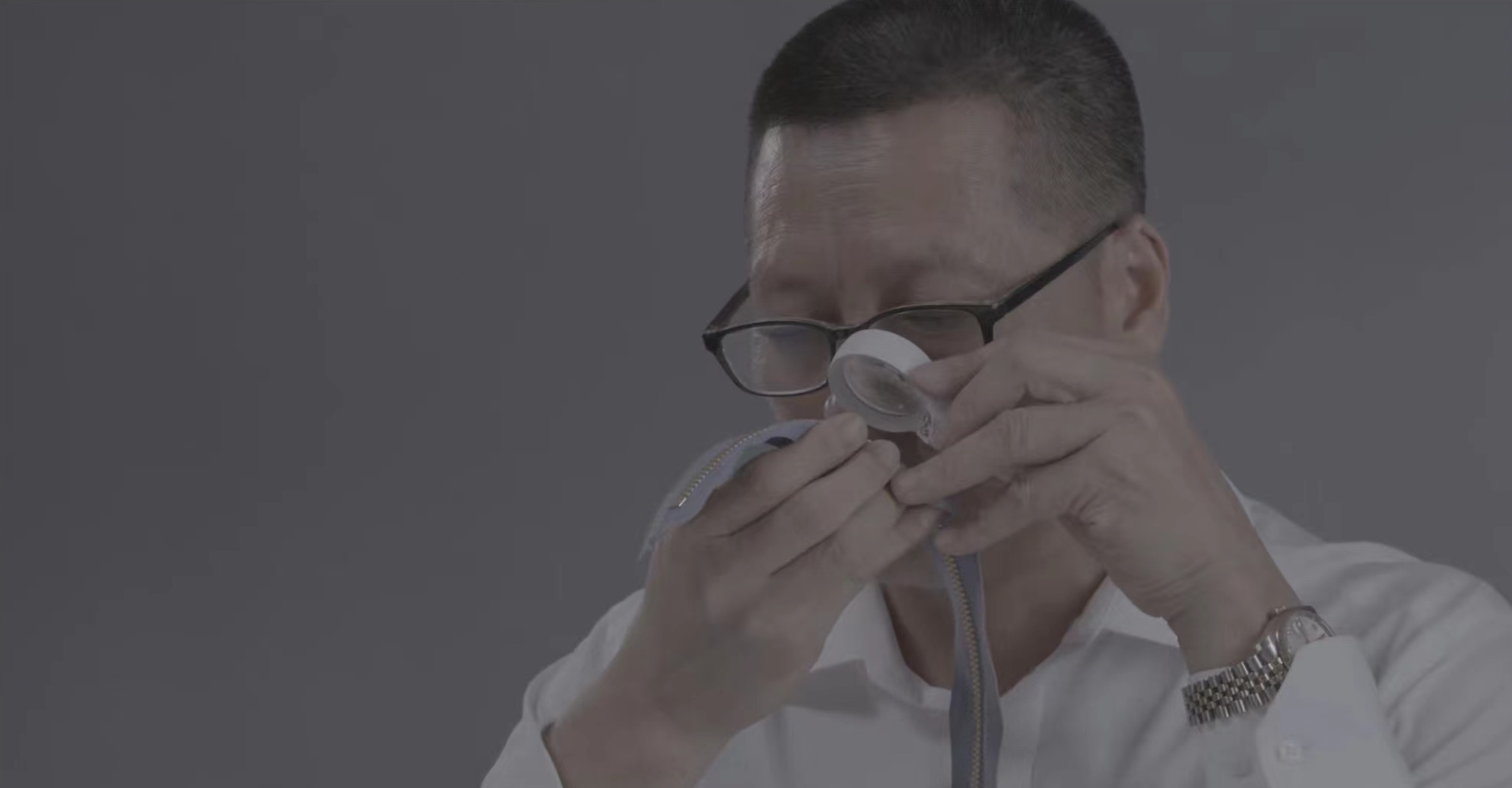 A MAM inspector examining a zipper through a loupe